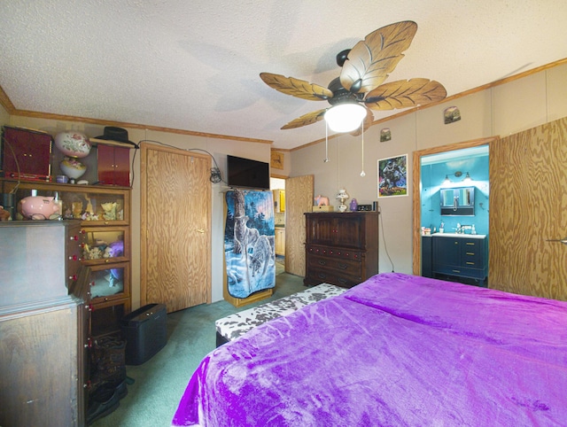 carpeted bedroom featuring ceiling fan, crown molding, ensuite bathroom, and a textured ceiling