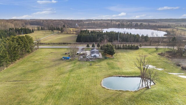 birds eye view of property with a water view and a rural view