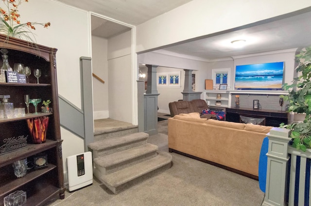 carpeted living room with decorative columns