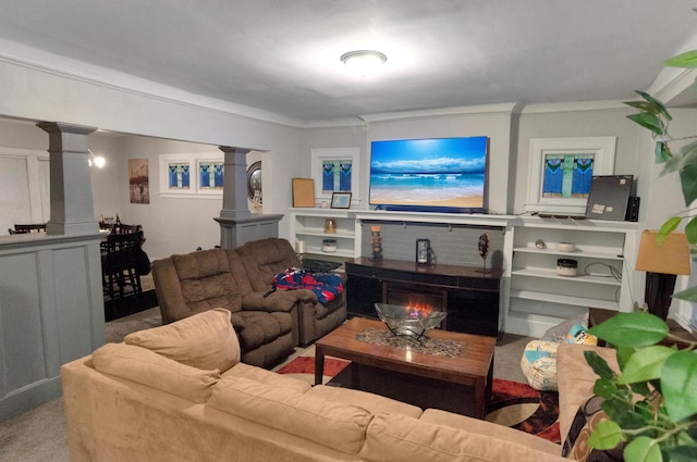 carpeted living room with decorative columns