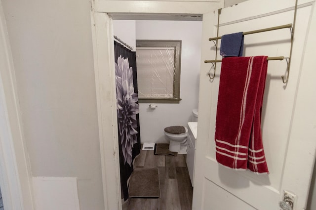 bathroom featuring hardwood / wood-style floors, vanity, and toilet