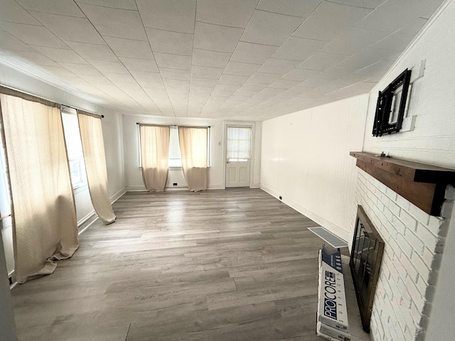 unfurnished living room featuring wood-type flooring and a fireplace