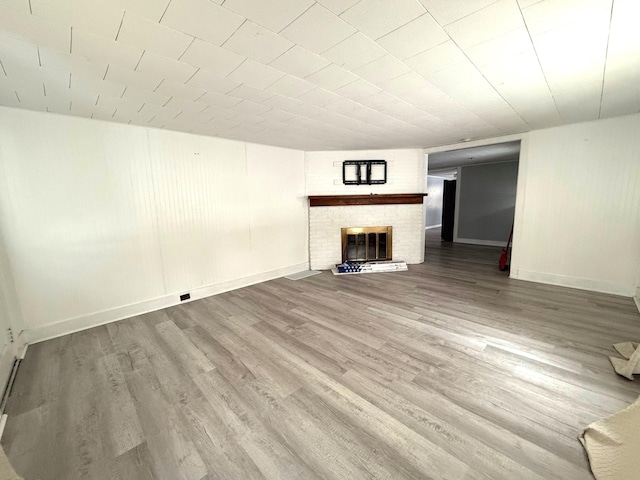 unfurnished living room with hardwood / wood-style floors and a fireplace