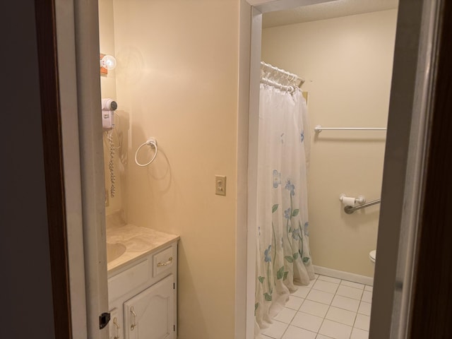 bathroom featuring curtained shower, vanity, and tile patterned floors