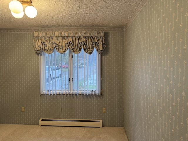 carpeted empty room featuring a textured ceiling, baseboard heating, and crown molding