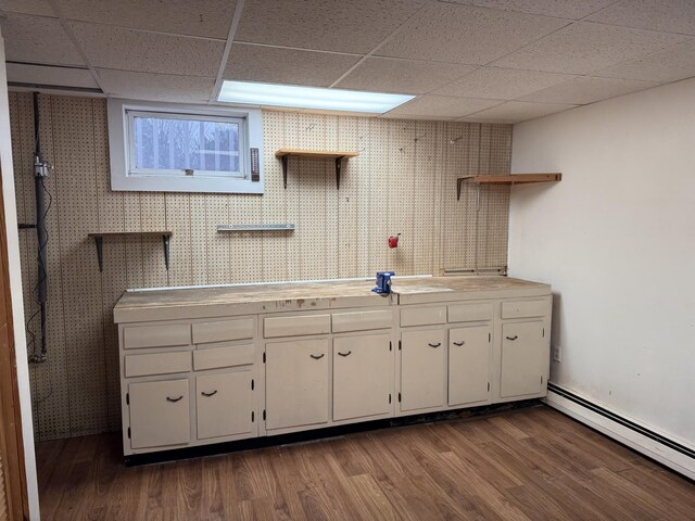 kitchen with baseboard heating, white cabinets, a paneled ceiling, and dark hardwood / wood-style floors