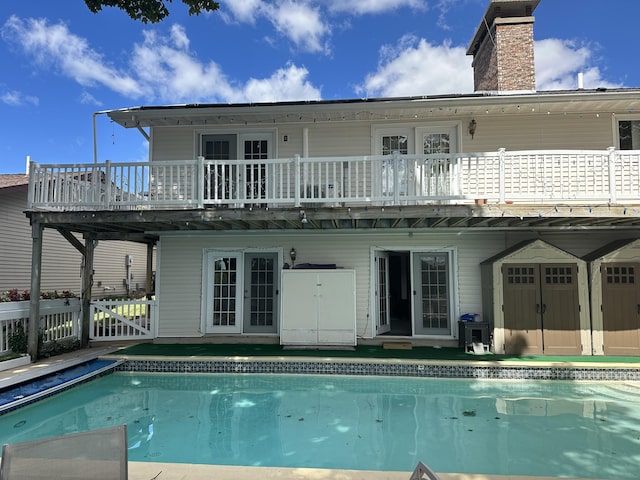 rear view of house with a swimming pool side deck