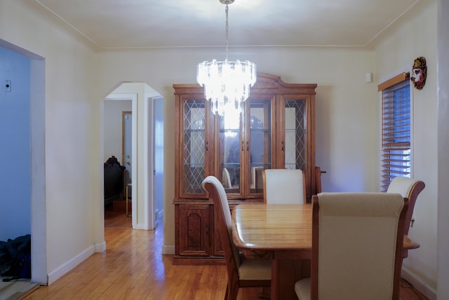 dining area with an inviting chandelier and light wood-type flooring