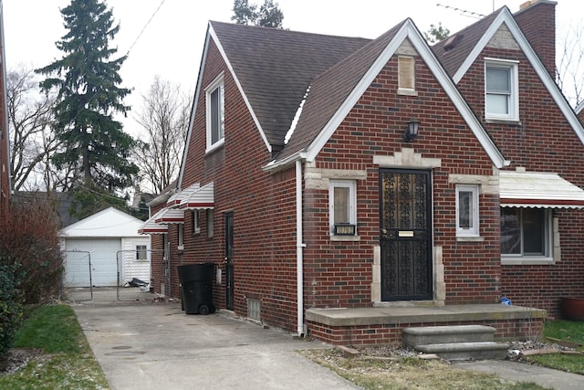 view of front of home with a garage and an outdoor structure