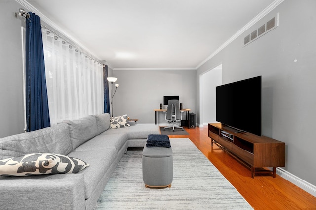 living room featuring wood-type flooring and ornamental molding