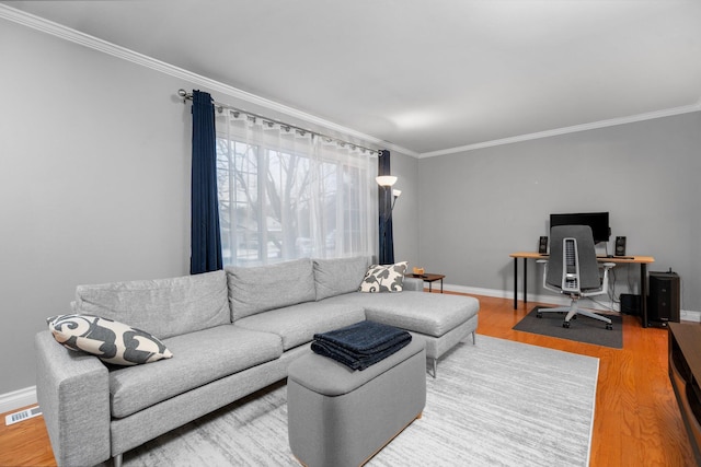 living room featuring hardwood / wood-style flooring and ornamental molding