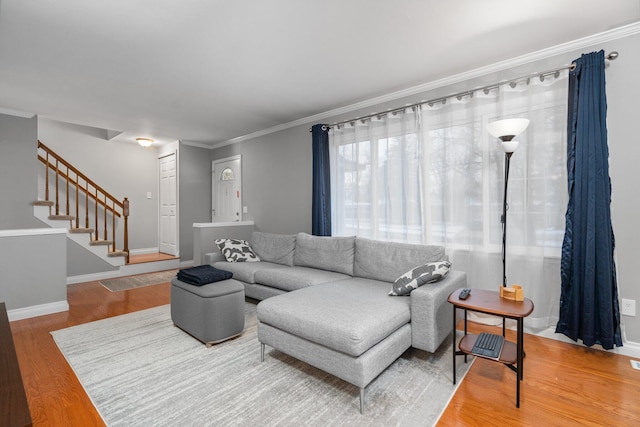 living room with ornamental molding and hardwood / wood-style flooring