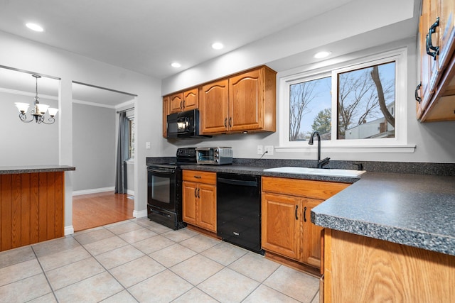 kitchen featuring ornamental molding, sink, black appliances, decorative light fixtures, and an inviting chandelier