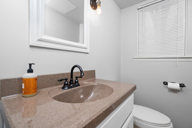 bathroom featuring vanity and toilet