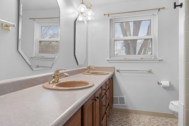 bathroom featuring tile patterned flooring, vanity, and toilet