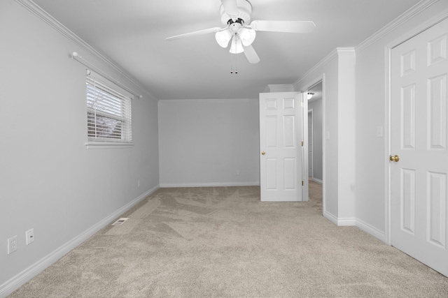 unfurnished bedroom with light colored carpet, ceiling fan, and ornamental molding