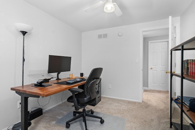 home office with light carpet and ceiling fan