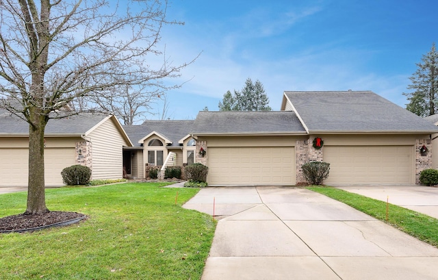 ranch-style house featuring a front lawn and a garage