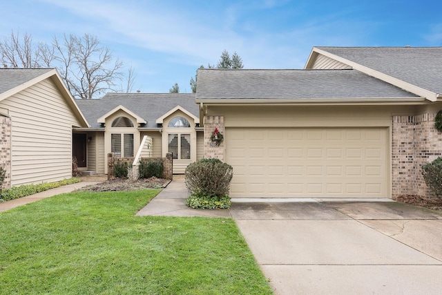 view of front of house with a front yard and a garage