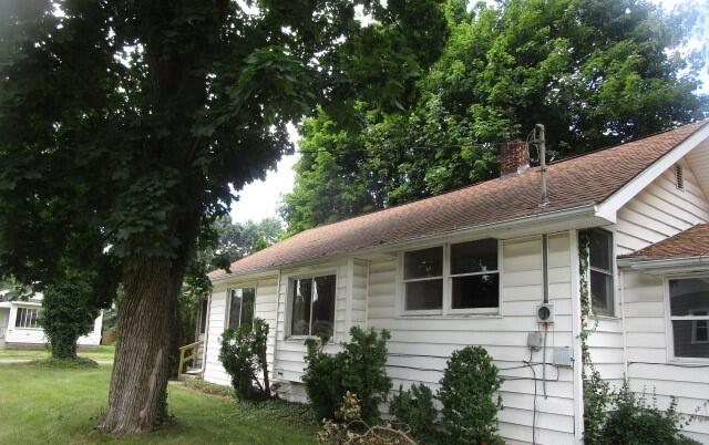 view of side of property with a yard