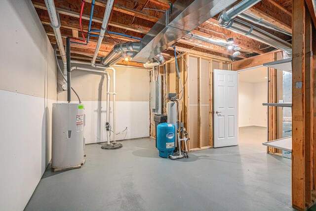 basement with electric panel and electric water heater