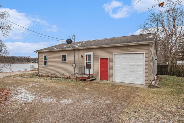 rear view of property with a garage