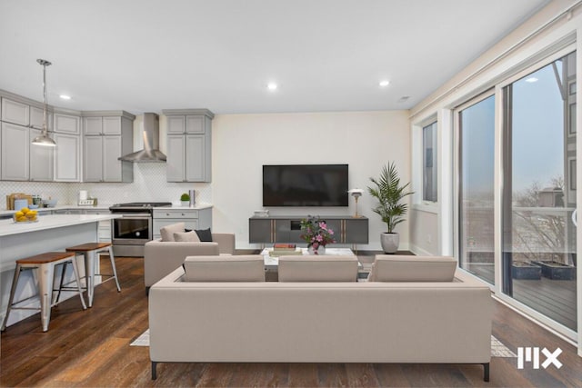 living room with dark wood finished floors and recessed lighting