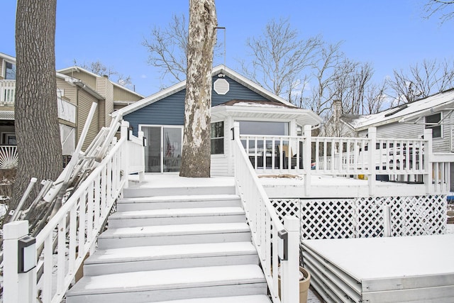 rear view of property featuring a deck