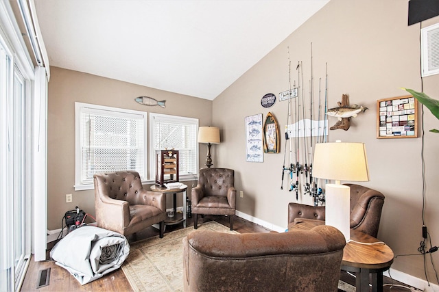 living area with hardwood / wood-style floors and lofted ceiling