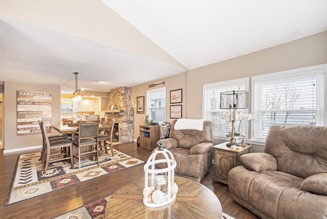 living room featuring a fireplace, hardwood / wood-style floors, and lofted ceiling