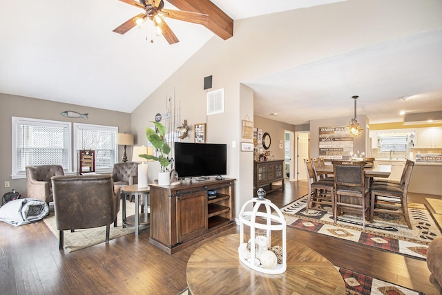 living room featuring hardwood / wood-style floors, lofted ceiling with beams, ceiling fan, and plenty of natural light