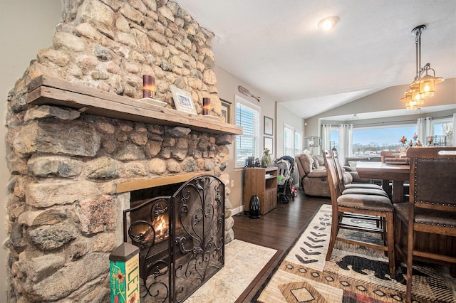 living room with a fireplace, hardwood / wood-style floors, and vaulted ceiling