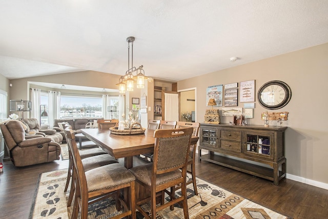 dining space with dark hardwood / wood-style flooring and vaulted ceiling