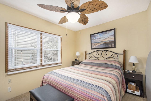 bedroom with ceiling fan, carpet floors, and multiple windows