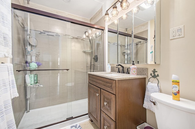 bathroom with vanity, toilet, and walk in shower