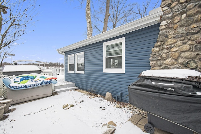 snow covered property featuring a deck