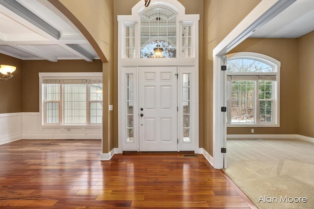 entrance foyer with beamed ceiling, dark wood-type flooring, and coffered ceiling