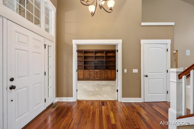 entryway featuring a chandelier and dark hardwood / wood-style floors