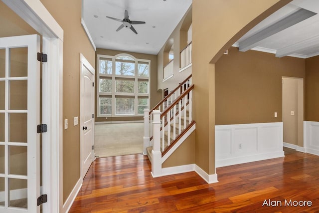 entryway featuring beam ceiling, ceiling fan, hardwood / wood-style floors, and crown molding