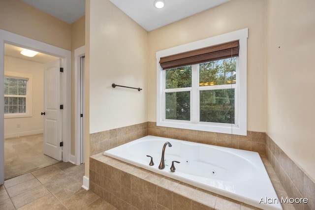 bathroom featuring tiled bath and tile patterned flooring