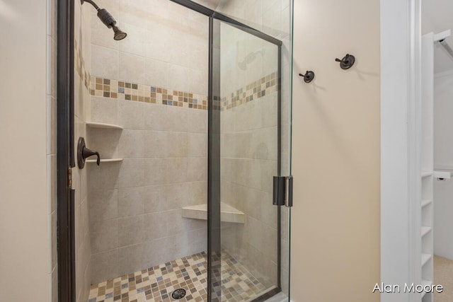 bathroom featuring a shower with door