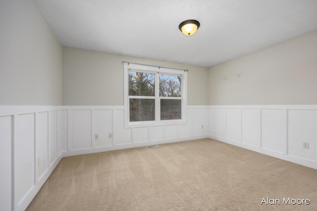 unfurnished room with light carpet