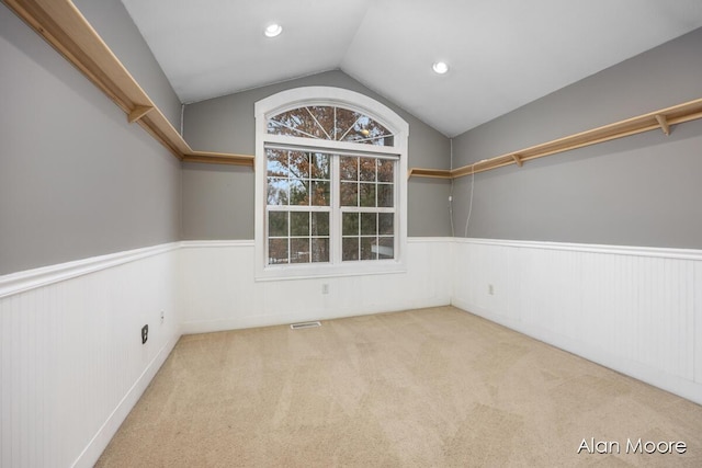 interior space with light carpet and lofted ceiling