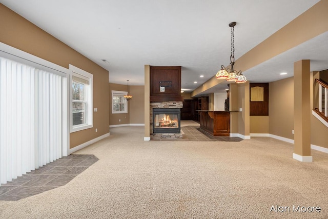 unfurnished living room featuring light carpet and a fireplace