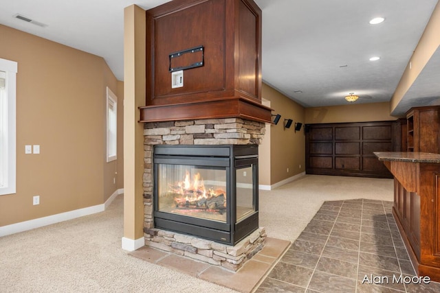 living room with a fireplace and carpet floors