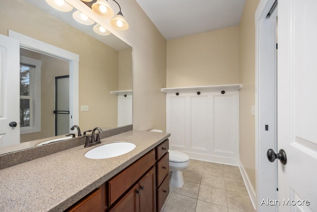 bathroom with tile patterned floors, vanity, and toilet