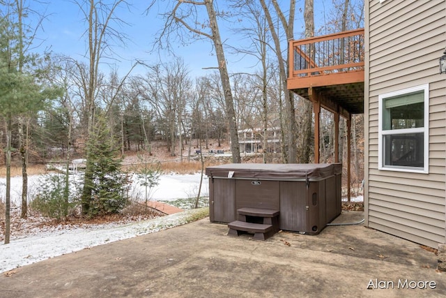 exterior space with a wooden deck and a hot tub