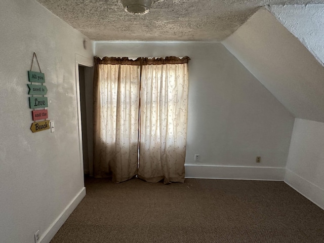 bonus room with a textured ceiling, carpet flooring, and lofted ceiling