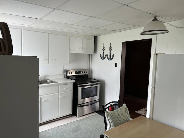 kitchen with white cabinets, decorative light fixtures, stainless steel range with electric stovetop, and white refrigerator