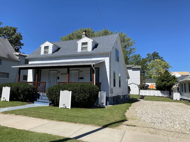 view of front of property with covered porch and a front lawn